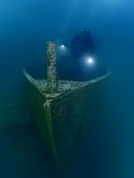 Scuba diver exploring ship wreck photo shipwreck Stock Photos