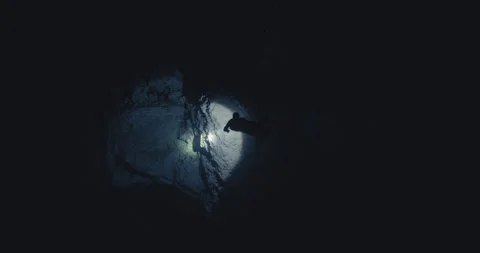 Scuba Diver with a Flashlight in a cave Video stock 270123957