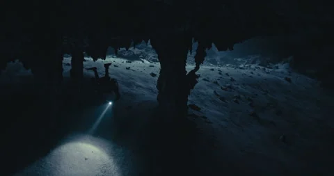 A Scuba Diver with a Flashlight exploring a cave Stock Footage 270128651
