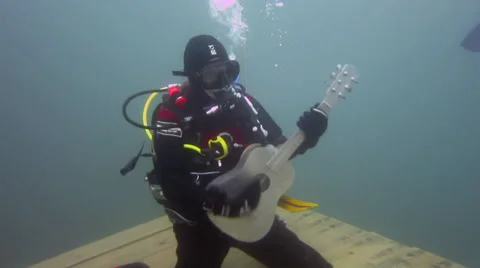 Scuba Diver having fun with a guitar Stock Footage 48587760