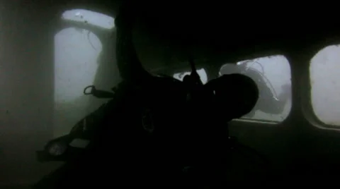 Scuba Diver inside plane wreck Stock Footage 48587931