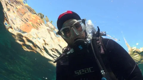 Scuba diver looking down from surface Stock Footage 70820113