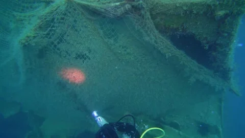 Scuba Diver is Looking at the Missing Ghost Net Underwater Stock Footage 143476934