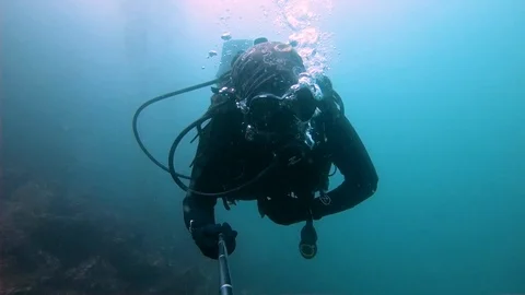 Scuba Diver is Moving Underwater Stock Footage 129113840