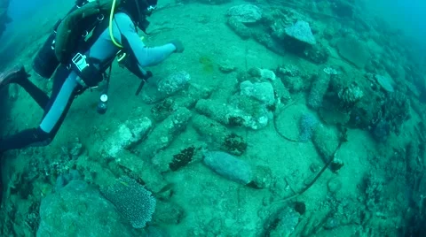 Scuba diver playing with torpedoes on ocean floor Stock Footage 40731657