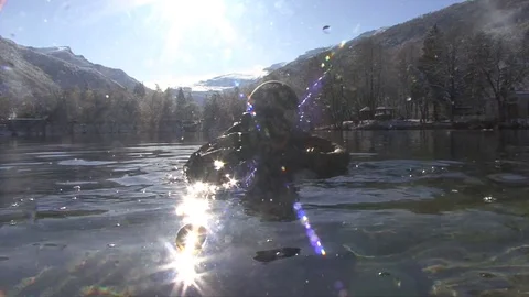 A SCUBA diver preparing for a dive in a mountain lake Stock Footage 83102759