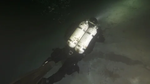 Scuba diver scours the bottom of the lake, Albano lake, Italy Stock Footage 107787651