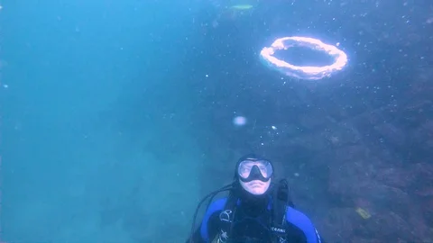 Scuba Diver Shapes Bubble Ring and Goes Video stock 129115457