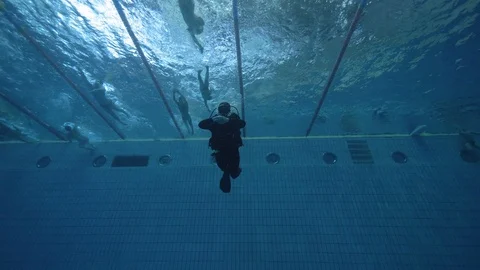 Scuba diver swimming in deep pool underwater view. Diving course in deep pool Stock Footage 86243621