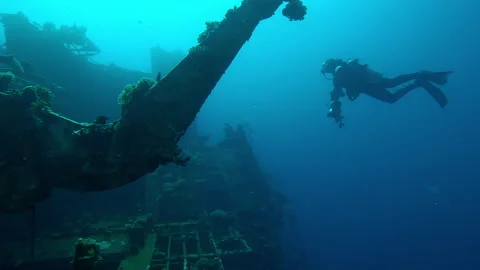 Scuba diver swimming next to superstructure on wreckship of Salem Express 스톡 동영상 322871656