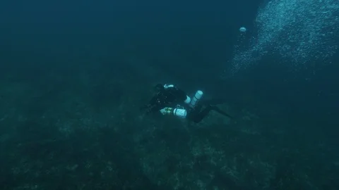 Scuba diver swims with bubbles on the seabed, Giannutri, Mediterranean sea,Italy Stock Footage 108111132