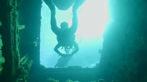 Scuba diver swims to exit inside cramped hold of ferry Salem Express shipwreck Stock Footage 243180192