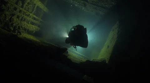 Scuba diver swims inside the shipwreck corridor - Umbria shipwreck, Red sea Stock Footage