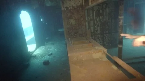 Scuba Diver Swims Through Ship Compartment Stock Footage 75798668