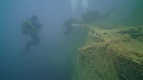 Scuba Divers are Rescuing the Ghost Net Underwater Stock Footage 143491054