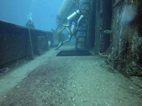 Scuba Divers Enter into Sunken Ship Video stock 75799069