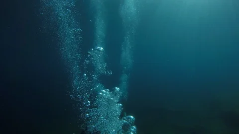 SCUBA divers explore a ship wreck in blue water as seen from a GoPro Vidéo 115011074