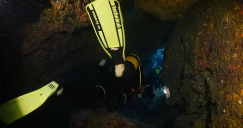 Scuba divers exploring the caves underwater cave diving Stock Footage 103824835
