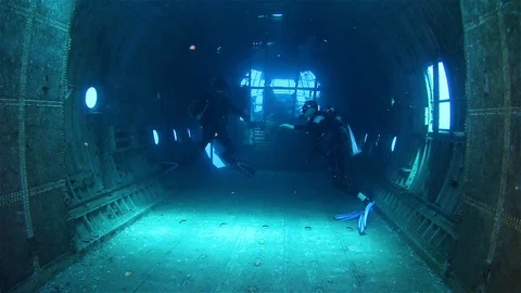Scuba Divers Exploring Inside Big Airplane C130 Wreck Stock Footage 125862243
