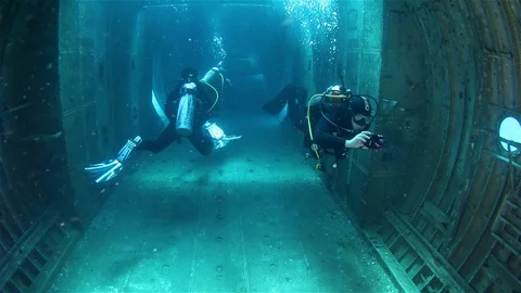 Scuba Divers Exploring Inside Big Airplane C130 Wreck Stock Footage 126325012