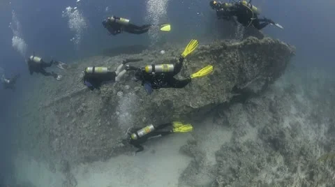 Scuba Divers exploring outside of a shipwreck (SS Dunraven) Stock Footage 8966135