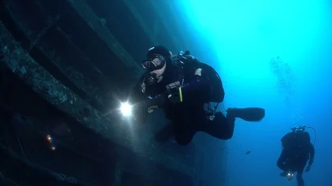 SCUBA divers exploring  the shipwreck Zenobia, underwater, Cyprus Stock Footage 82756008