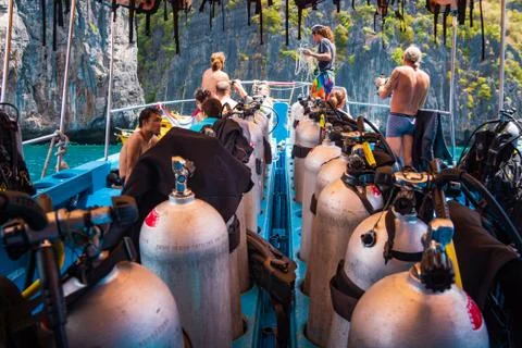 Scuba divers getting ready for diving on a boat full of equipment, Thailand Stock Photos