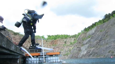 Scuba Divers jumping in - Camera on Surface then goes underwater Stock Footage 48586576