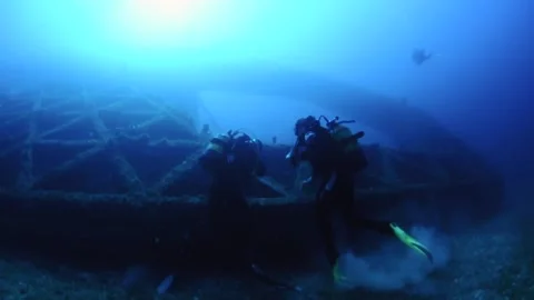 Scuba divers at La Plataforma wreck (Ses Salines Natural Park,Mediterranean Sea) Stock Footage 213353039