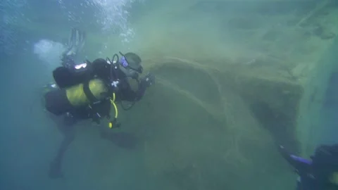 Scuba Divers Pull the Ghost Net Under the Sea Stock Footage 143525306