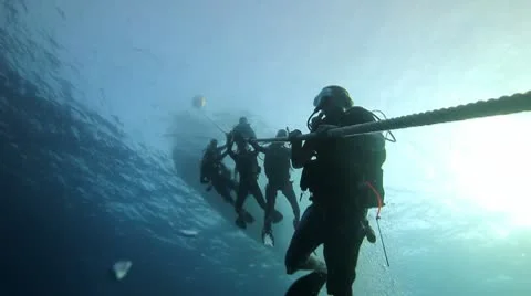 Scuba divers on rope silhouette Stock Footage 10801133