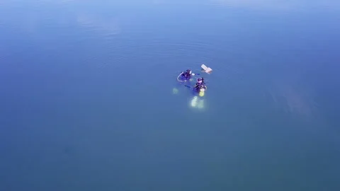 Scuba Divers Swim to Marker Stock Footage 170787555