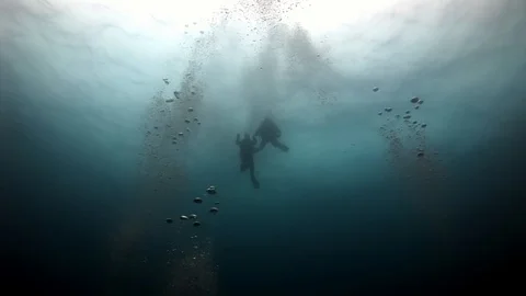 Scuba divers underwater on background of seabed. Stock Footage 89723074