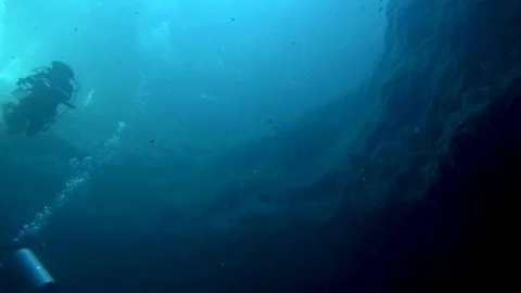 Scuba divers in the Zapotec or Hell's Bells cenote in Mexico. Stock Footage 104110330