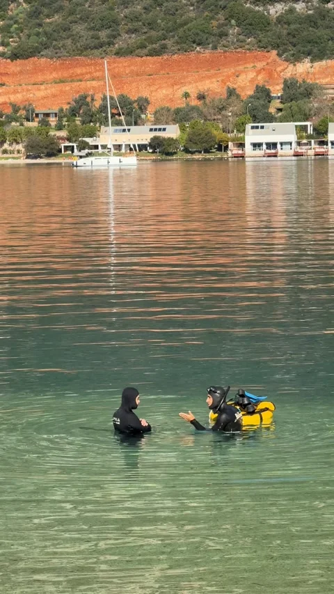 Scuba diving instruction in calm coastal waters with distant landscape and .. Stock Footage 324707374