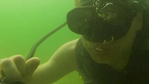 Scuba diving instructor shows how to clean regulator Stock Footage 125101229