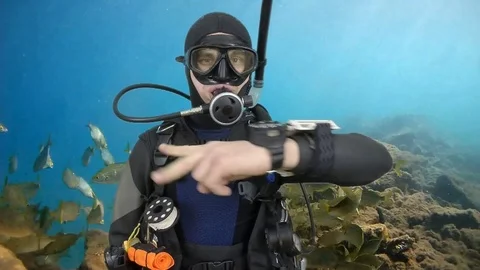 Scuba diving instructor shows signal – swimming Stock Footage 123382481