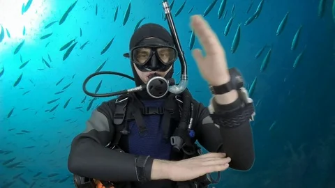Scuba diving instructor shows signal – Pivot Stock Footage 129777226