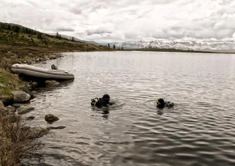 Scuba diving in a mountain lake, practicing techniques for emergency rescuers 스톡 사진