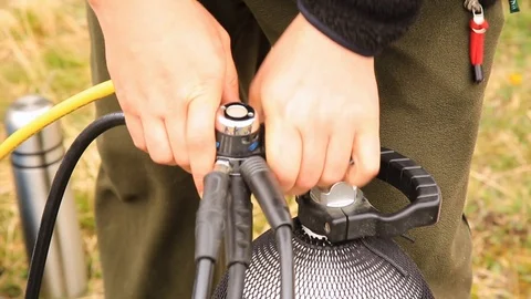 Scuba equipment in the process of being set up for a scuba dive. connection of Stock Footage 113333995