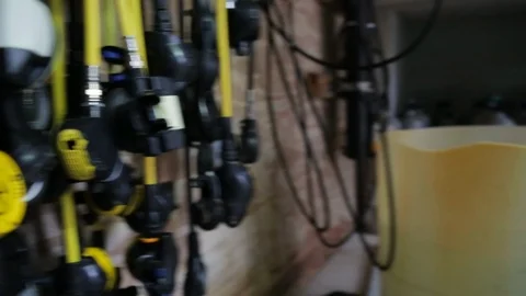 Scuba regulators hang on wall in dive shop Stock Footage 87373998