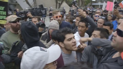 Scuffle between large man and Trump supporters at Donald Trump Rally Stock-Footage 81925399