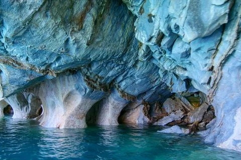 Sculpted blue chapels of  Marble caves or Cuevas de Marmol at turquoise Gen.. Stock Photos