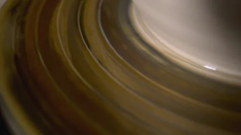 Sculpting a shape of clay item. Close up shot of a pot rotating on pottery wheel Video stock 145009449