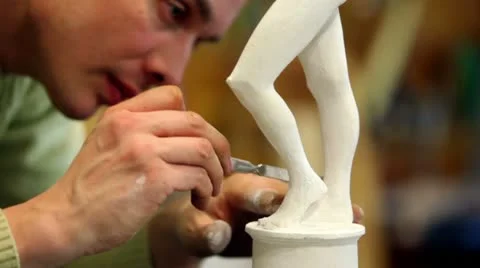 Sculptor corrects malleolus of figurine by special tool Stock Footage