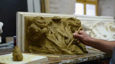 Sculptor create clay model of a Corinthian capitel with acanthus leaves Stock Footage 132211585