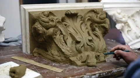 Sculptor create clay model of a Corinthian capitel with acanthus leaves Stock Footage 132211793