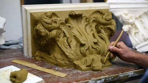 Sculptor create clay model of a Corinthian capitel with acanthus leaves Stock Footage 132211975