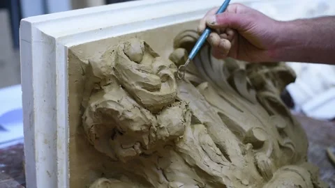 Sculptor create clay model of a Corinthian capitel with acanthus leaves Stock Footage 132212256