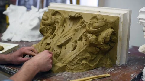 Sculptor create clay model of a Corinthian capitel with acanthus leaves Stock Footage 132212370